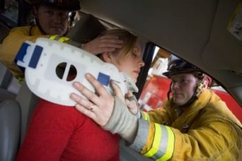 First responders are rescuing an injured woman in a car accident