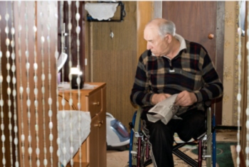 A senior sitting in a wheelchair at nursing home