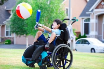 Boy in wheelchair holding a balloon