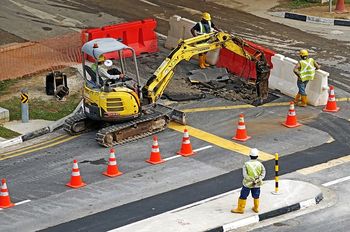 Construction workers are working in a road work zone