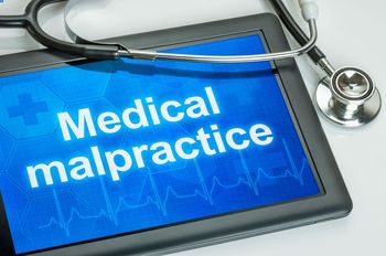 Medical malpractice shows on a pad's screen, a stethoscope
