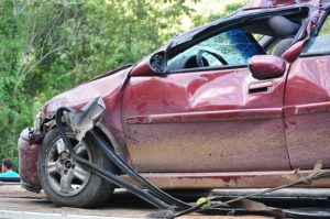 A seriously crashed red car