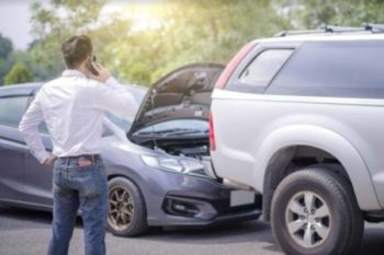 A man is calling at a scene of cars collision