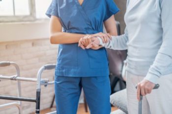 Nurse with a senior in a nursing home
