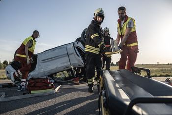 First responders are rescuing in a car crash scene
