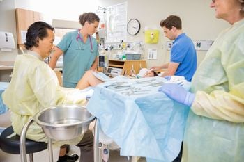 Midwives and nurses are helping a pregnant woman to deliver baby